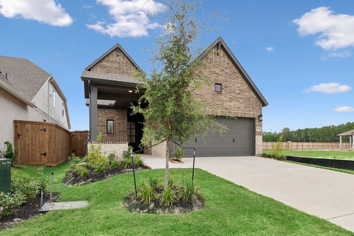 8731 Mancos Valley Porter, TX 77365 - Photo 2 of 46 a front view of a house with garden