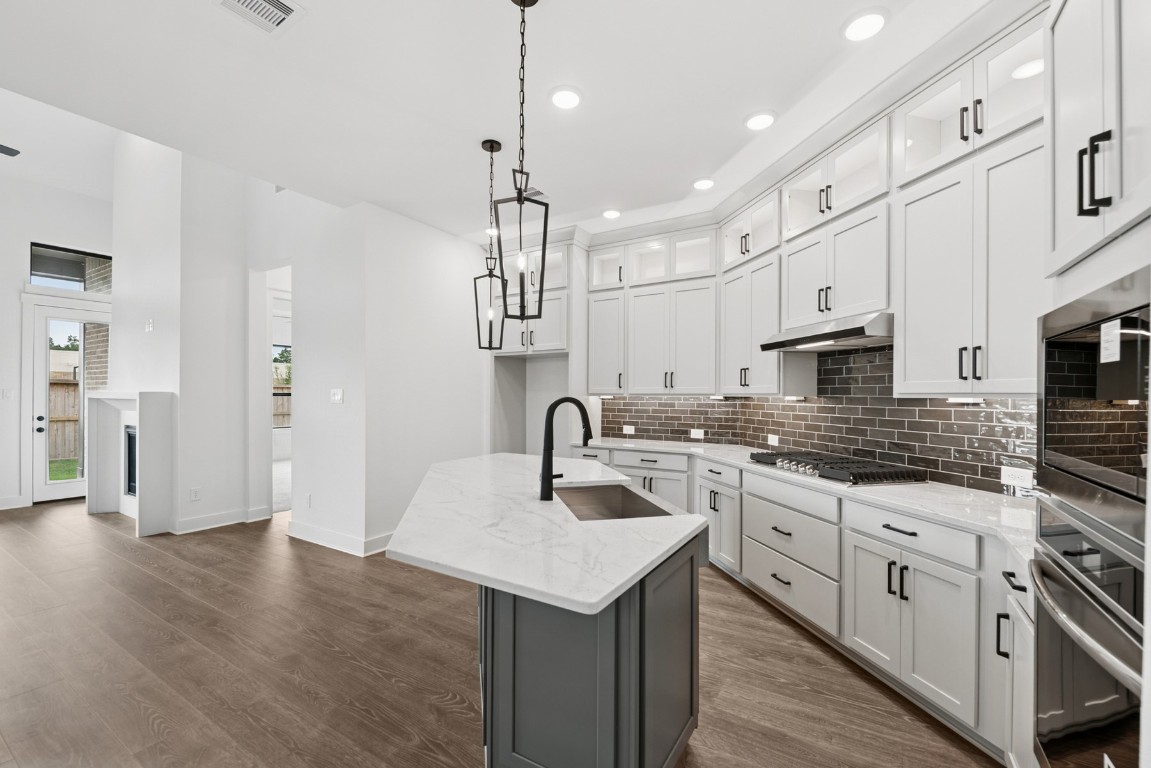 8731 Mancos Valley Porter, TX 77365 - Photo 19 of 46 a kitchen with stainless steel appliances granite countertop a sink a stove and a refrigerator