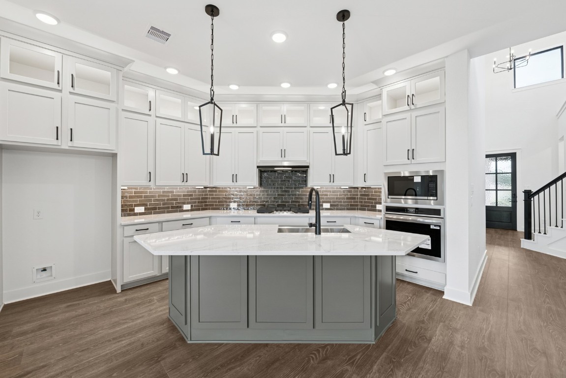 8731 Mancos Valley Porter, TX 77365 - Photo 20 of 46 a kitchen with kitchen island a counter space a sink appliances and cabinets