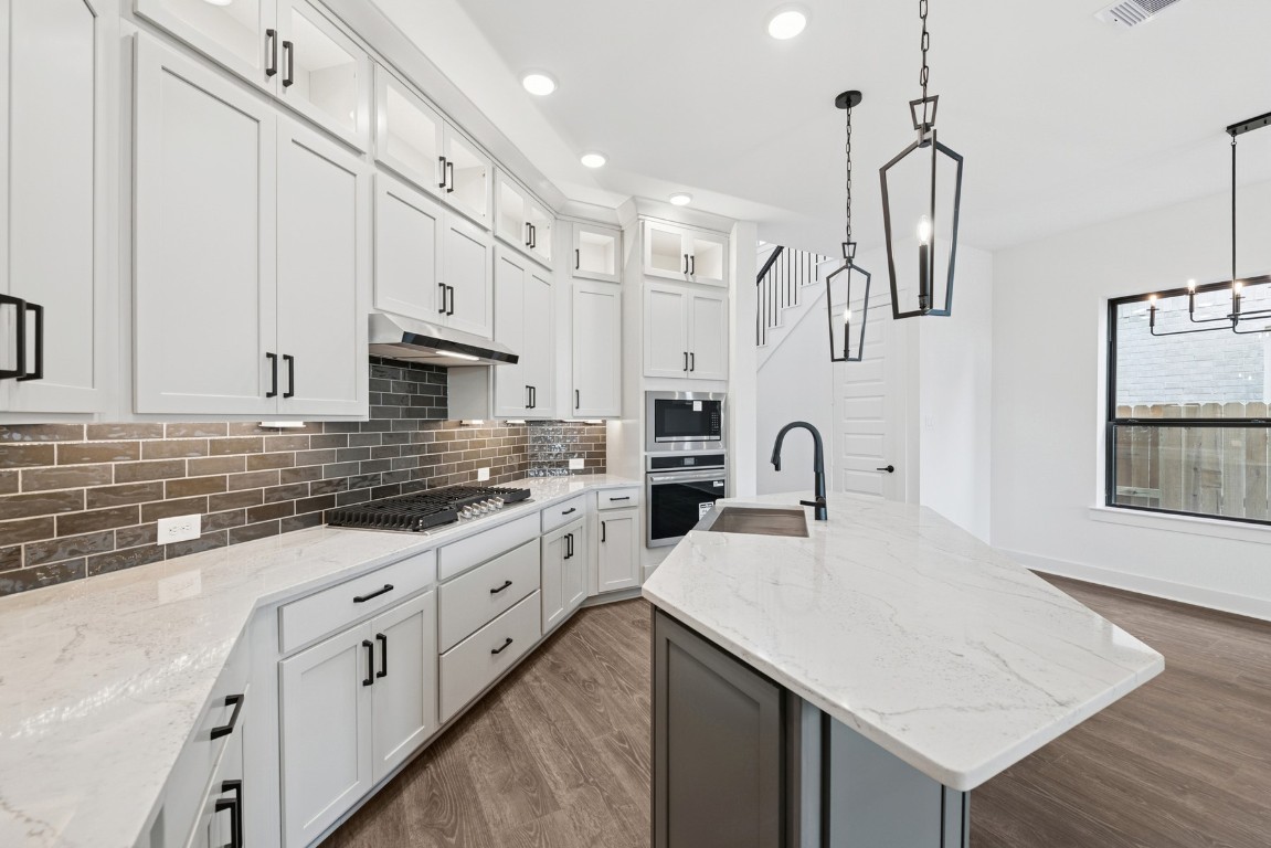 8731 Mancos Valley Porter, TX 77365 - Photo 21 of 46 a kitchen with white cabinets appliances and sink