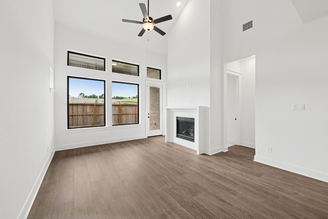 8731 Mancos Valley Porter, TX 77365 - Photo 24 of 46 a view of an empty room with a fireplace and a window