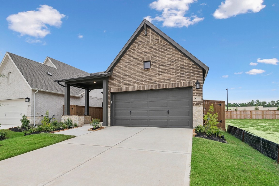 8731 Mancos Valley Porter, TX 77365 - Photo 3 of 46 a front view of a house with a garden and plants