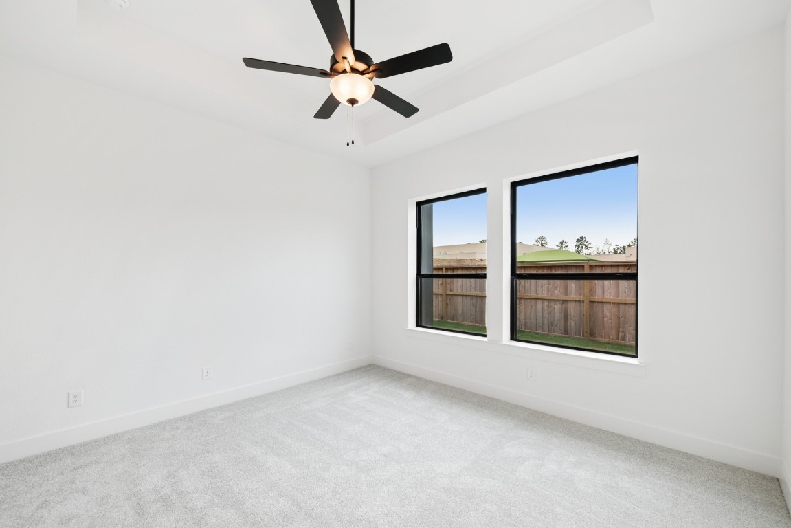 8731 Mancos Valley Porter, TX 77365 - Photo 31 of 46 an empty room with windows and fan
