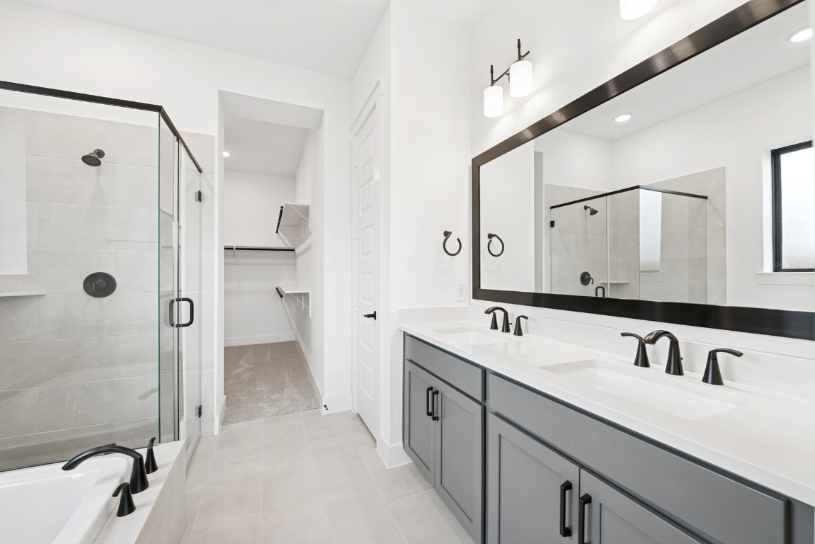 8731 Mancos Valley Porter, TX 77365 - Photo 32 of 46 a bathroom with a double vanity sink mirror double and shower