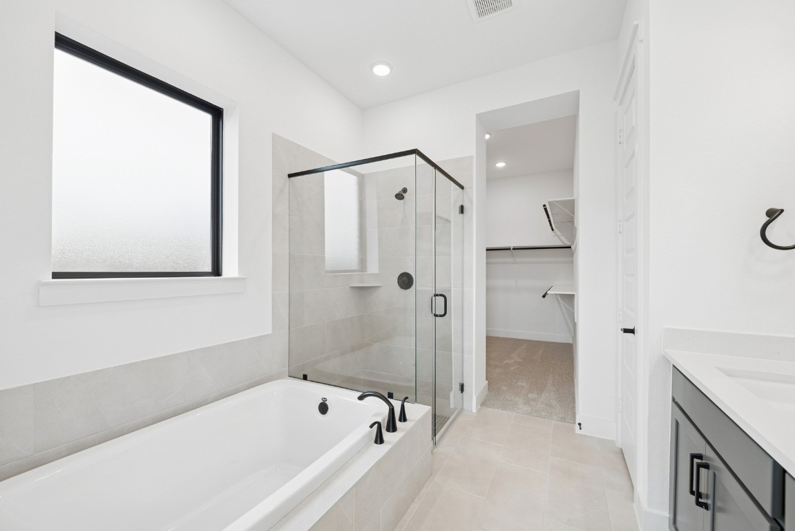 8731 Mancos Valley Porter, TX 77365 - Photo 33 of 46 a bathroom with a bathtub and a shower