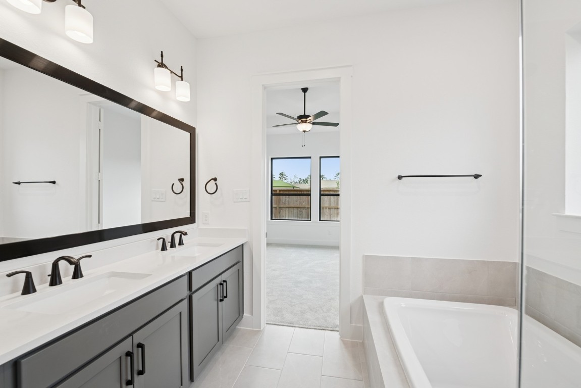 8731 Mancos Valley Porter, TX 77365 - Photo 34 of 46 a spacious bathroom with a tub sink and mirror