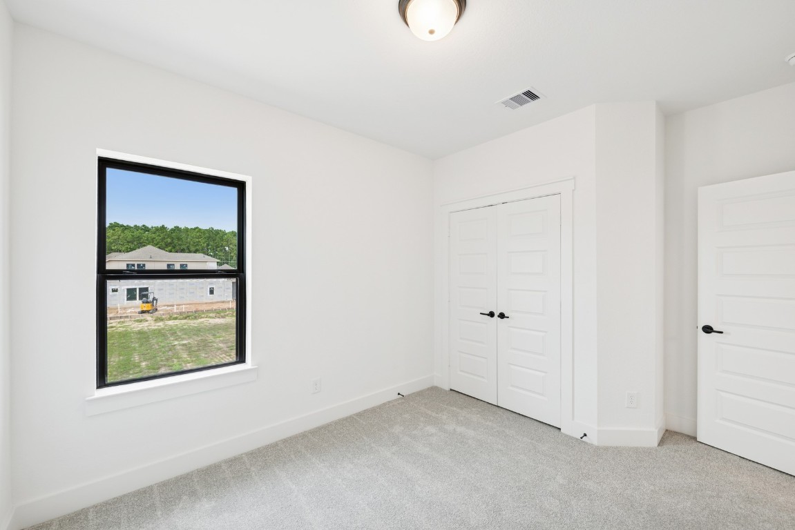 8731 Mancos Valley Porter, TX 77365 - Photo 39 of 46 a view of an empty room with closet and a window
