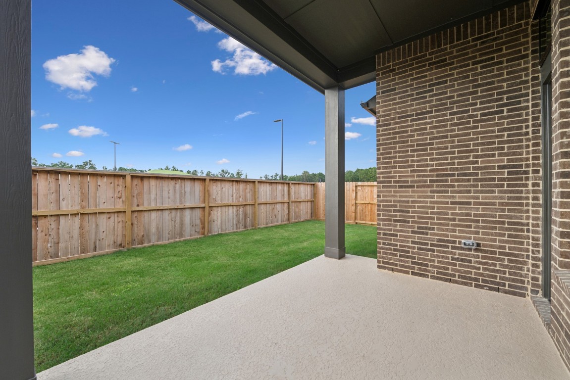 8731 Mancos Valley Porter, TX 77365 - Photo 7 of 46 a view of a backyard with brick wall