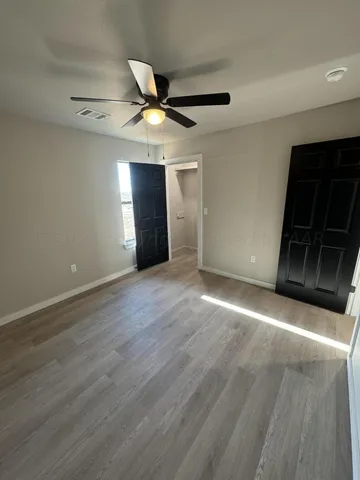 an empty room with windows and entrance