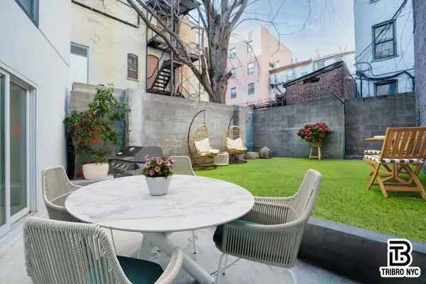 a view of a patio with couches chairs and a fire pit