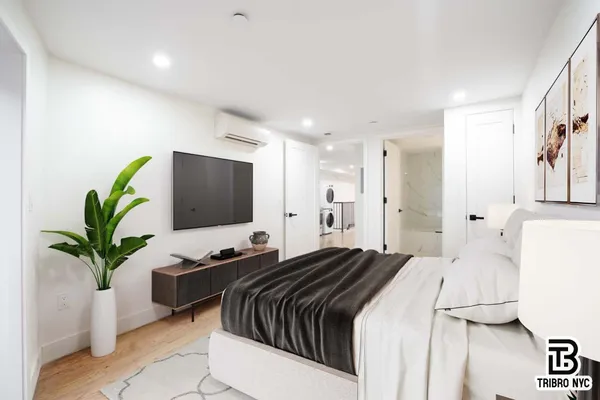 a bedroom with a bed and a potted plant