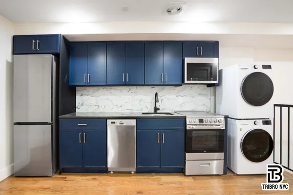 a kitchen with a sink a stove and cabinets