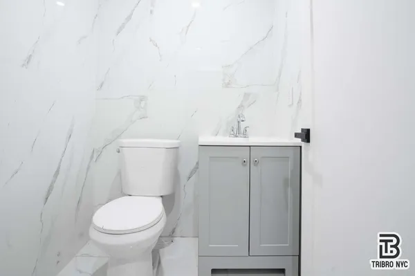 a bathroom with a sink a toilet and vanity