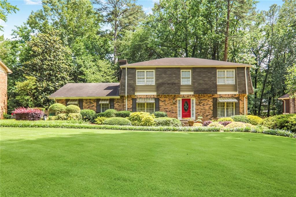 a front view of a house with garden
