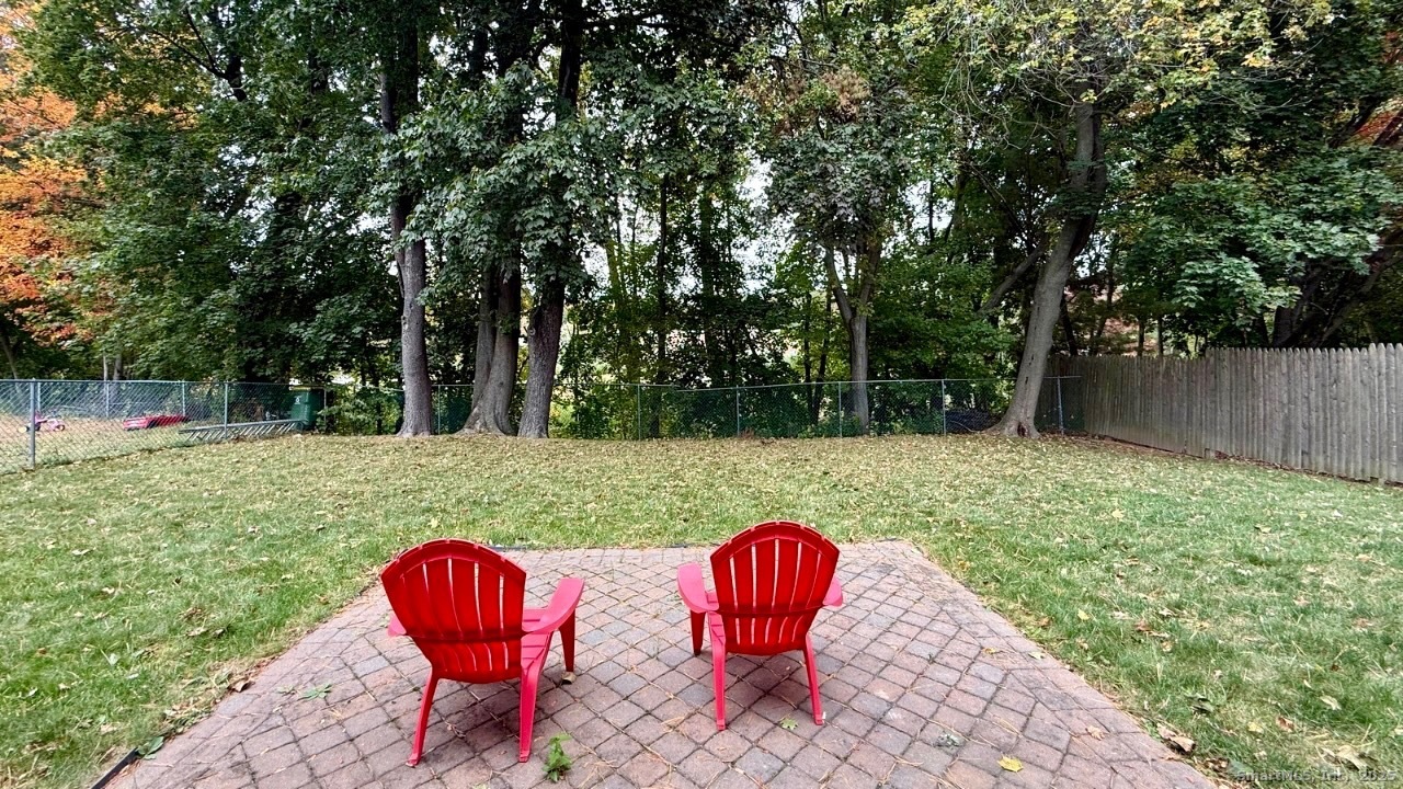 158 Monroe Avenue Waterbury, CT 06705 - Photo 11 of 12 a backyard of a house with table and chairs