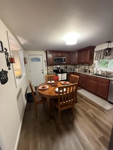 a dining room with kitchen island a table and chairs in it