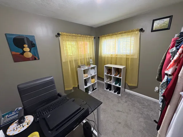 a living room with furniture and a piano