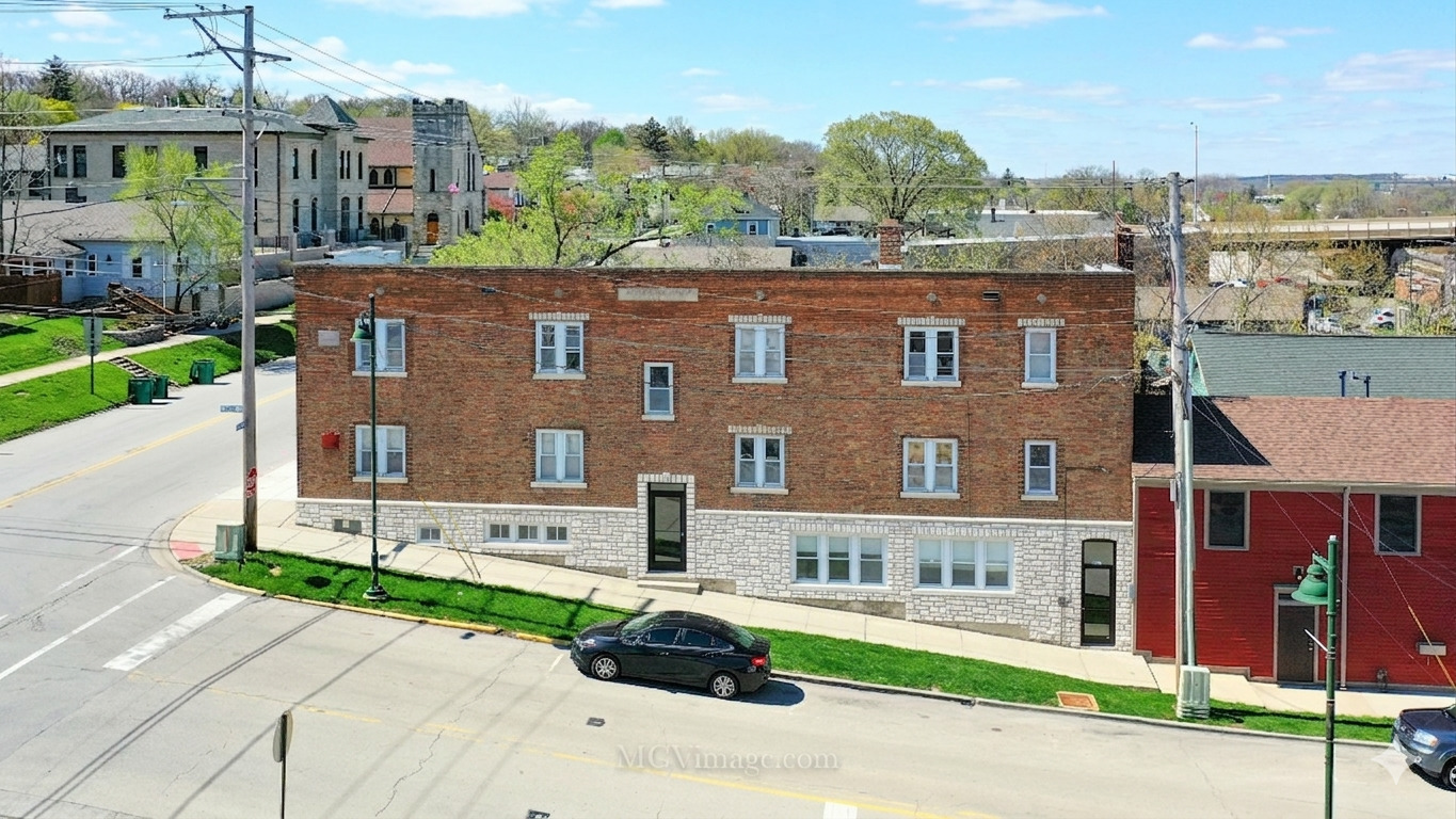 224 Lemont Street, Unit 5 Lemont, IL 60439 - Photo 2 of 21 a front view of a building with a garden and plants