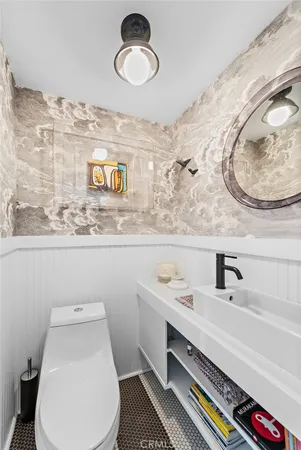 a bathroom with a sink mirror vanity and toilet