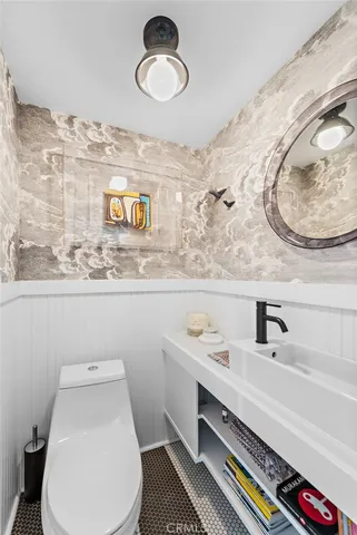 a bathroom with a sink mirror vanity and toilet