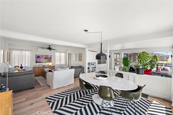 a view of a dining room with furniture window and wooden floor