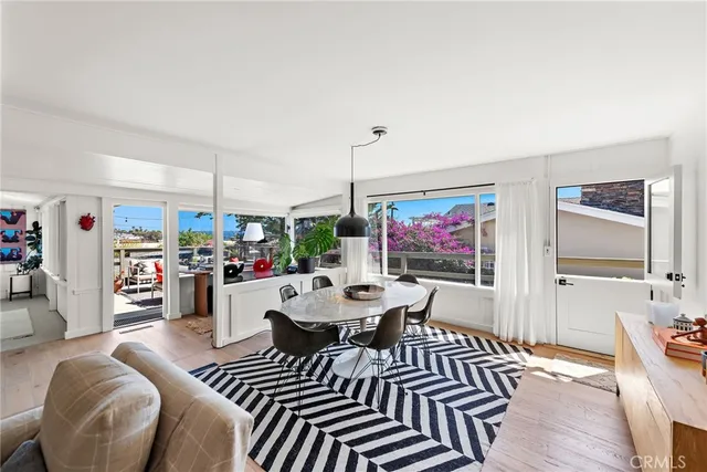 a living room with furniture a flat screen tv and kitchen view