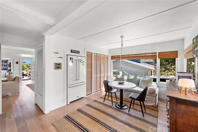 a dining room with furniture and wooden floor
