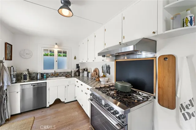 a kitchen with stainless steel appliances a stove a sink and a refrigerator