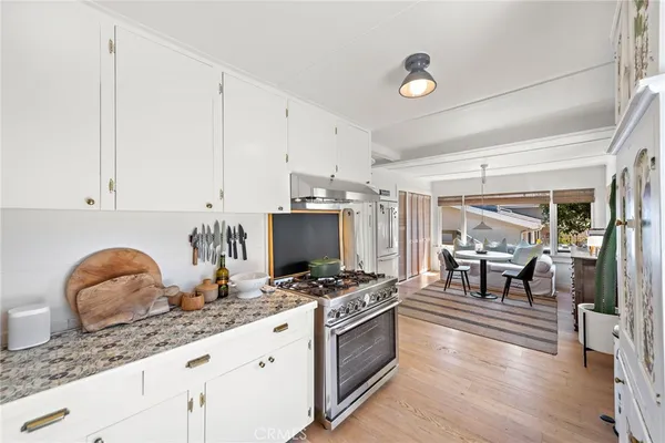 a kitchen with granite countertop a table and chairs in it