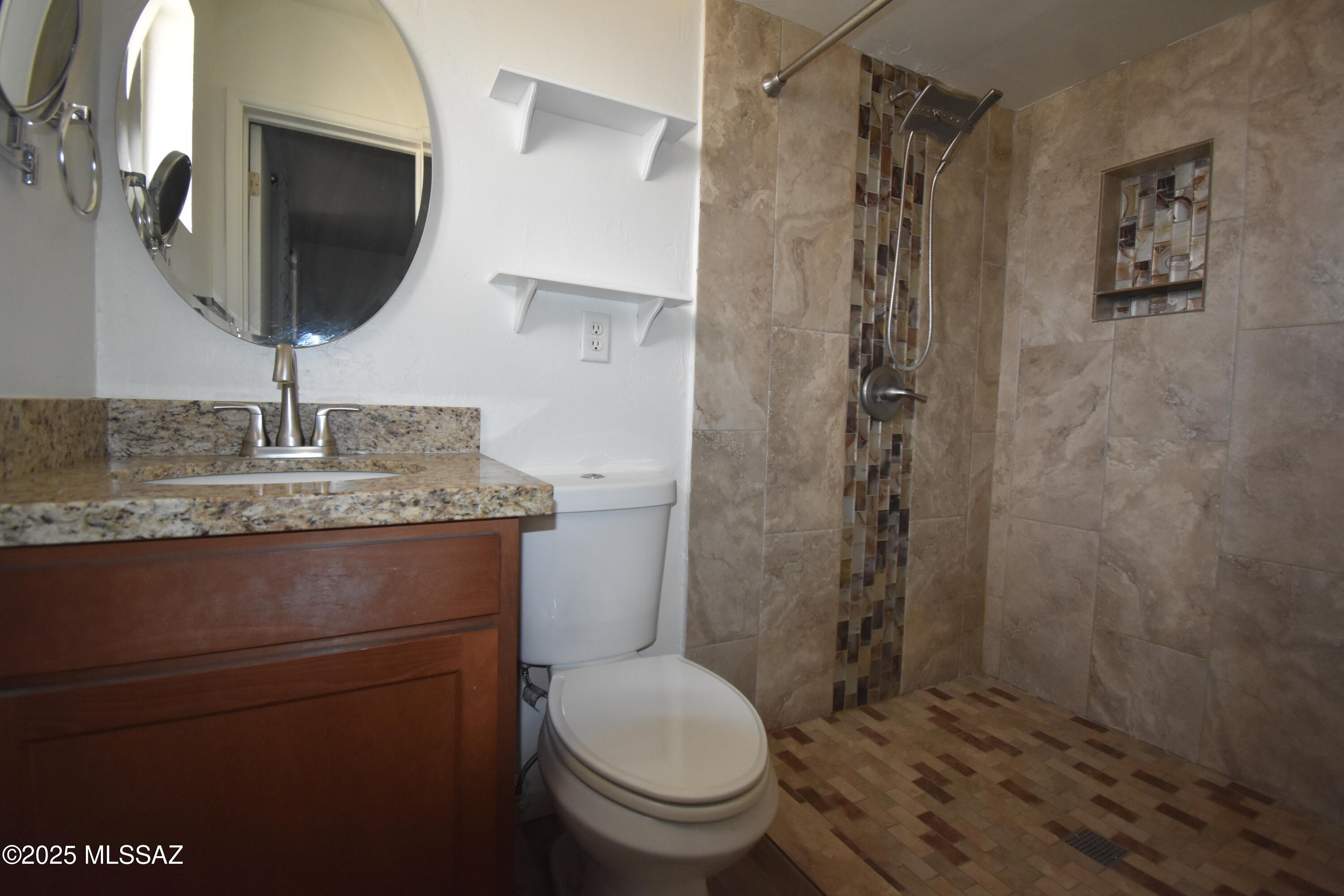 5501 East Spring Street Tucson, AZ 85712 - Photo 27 of 32 a bathroom with a granite countertop toilet sink and mirror