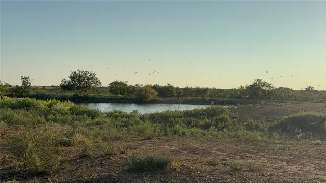 a view of a lake with a yard