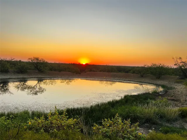 a view of a terrace with chairs and a grill