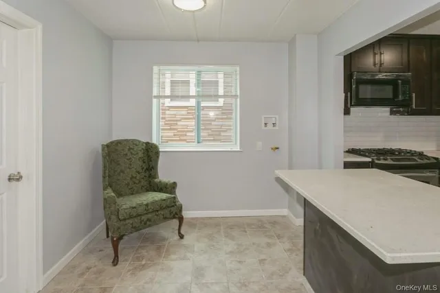 a living room with window and a table
