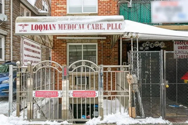 a front view of multi story building with retail shops