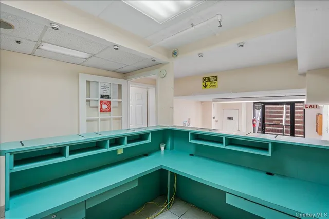 a kitchen with green walls and white cabinets
