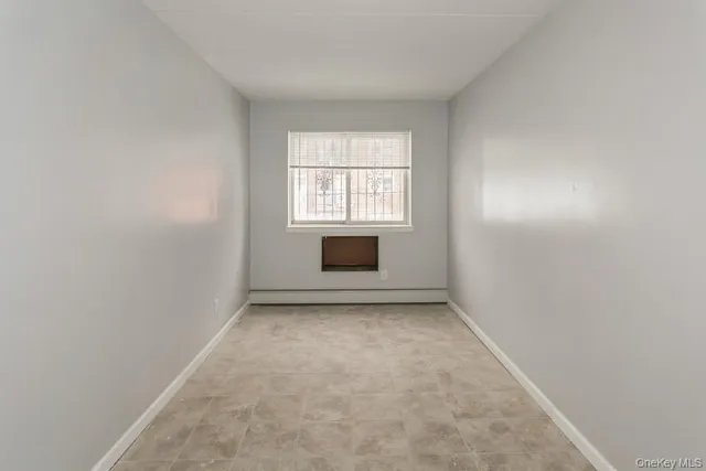 an empty room with a fireplace and a window