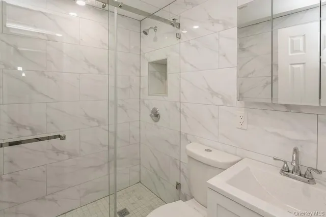 a bathroom with a sink toilet and shower