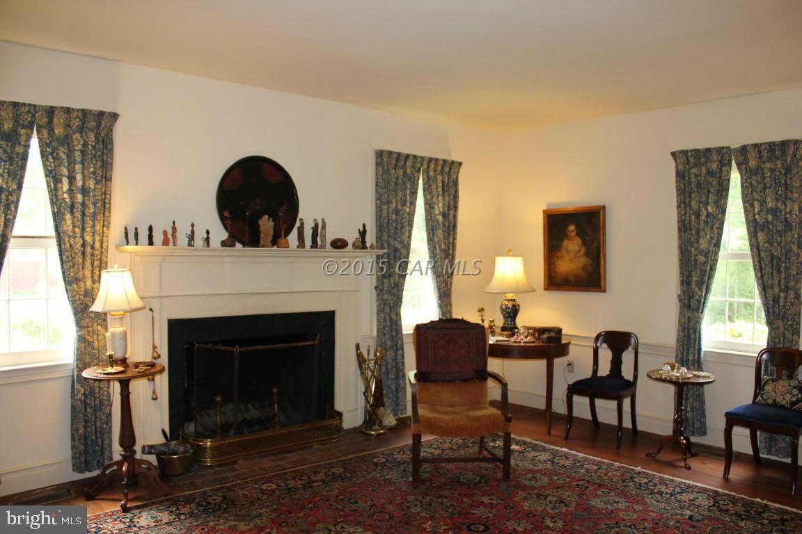 8579 Riggin Road Mardela Springs, MD 21837 - Photo 22 of 45 a living room with furniture a window and a fireplace