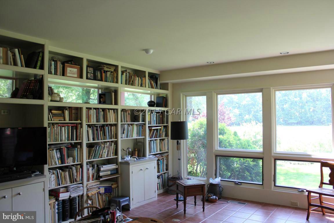 8579 Riggin Road Mardela Springs, MD 21837 - Photo 29 of 45 a living room with furniture and a book shelf