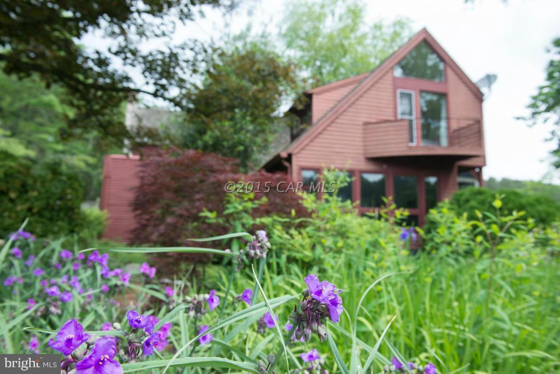 8579 Riggin Road Mardela Springs, MD 21837 - Photo 32 of 45 a view of a garden with flowers and wooden fence