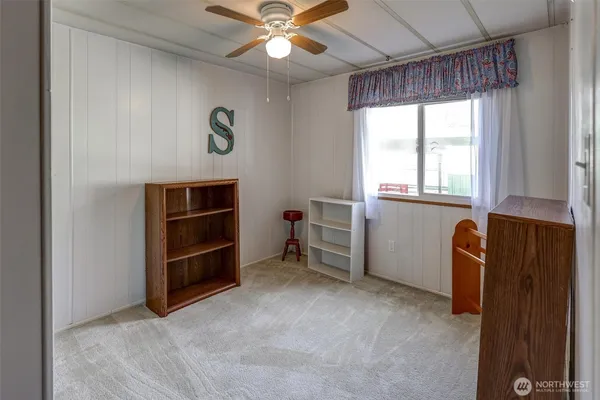 a view of room with window and a ceiling fan