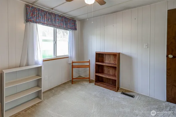 a view of an empty room and a window
