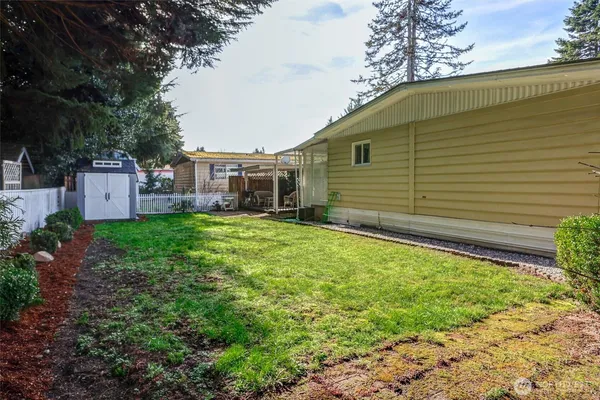 a backyard of a house with garden and patio