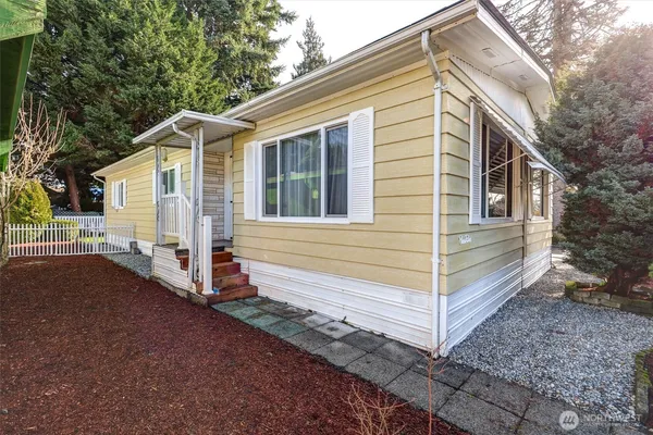 a view of house with a yard