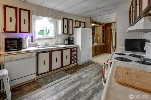 a kitchen with stainless steel appliances a stove refrigerator sink and a window