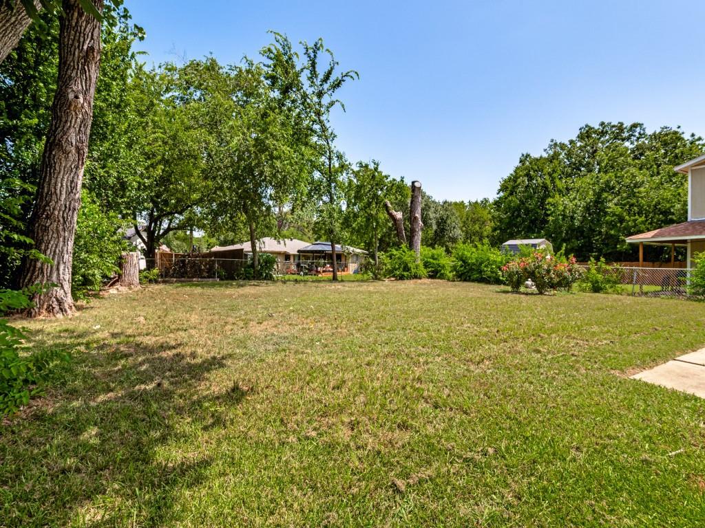1405 Rambler Road Arlington, TX 76014 - Photo 26 of 26 Spacious backyard featuring an expansive lawn area and mature perimeter trees