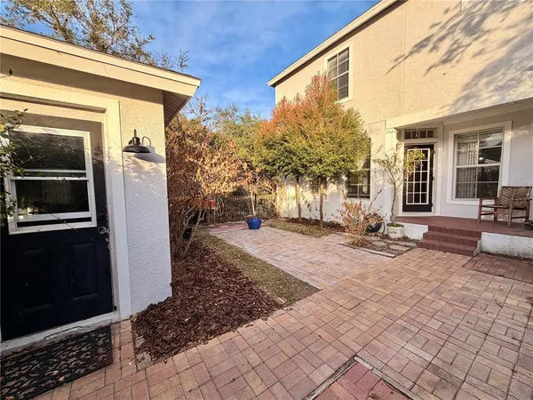 a view of a house with backyard and sitting area