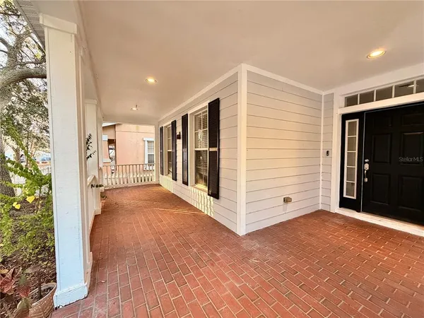 a view of a hallway with wooden floor and entryway