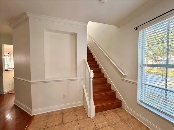 a view of entryway with wooden floor and stairs
