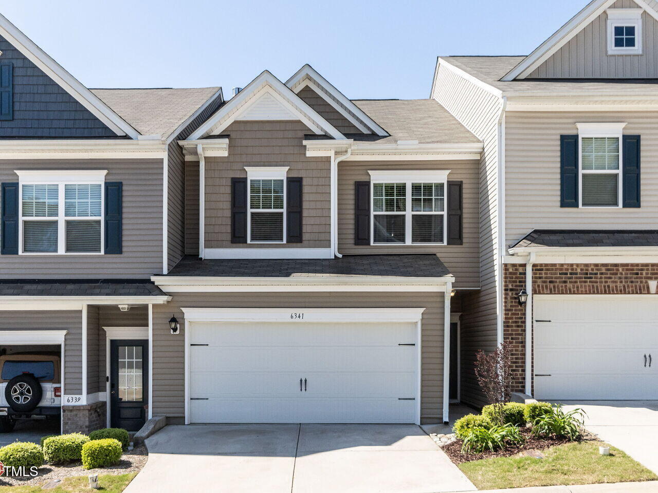 6341 Grace Lily Drive Raleigh, NC 27607 - Photo 1 of 29 a front view of a house with garden